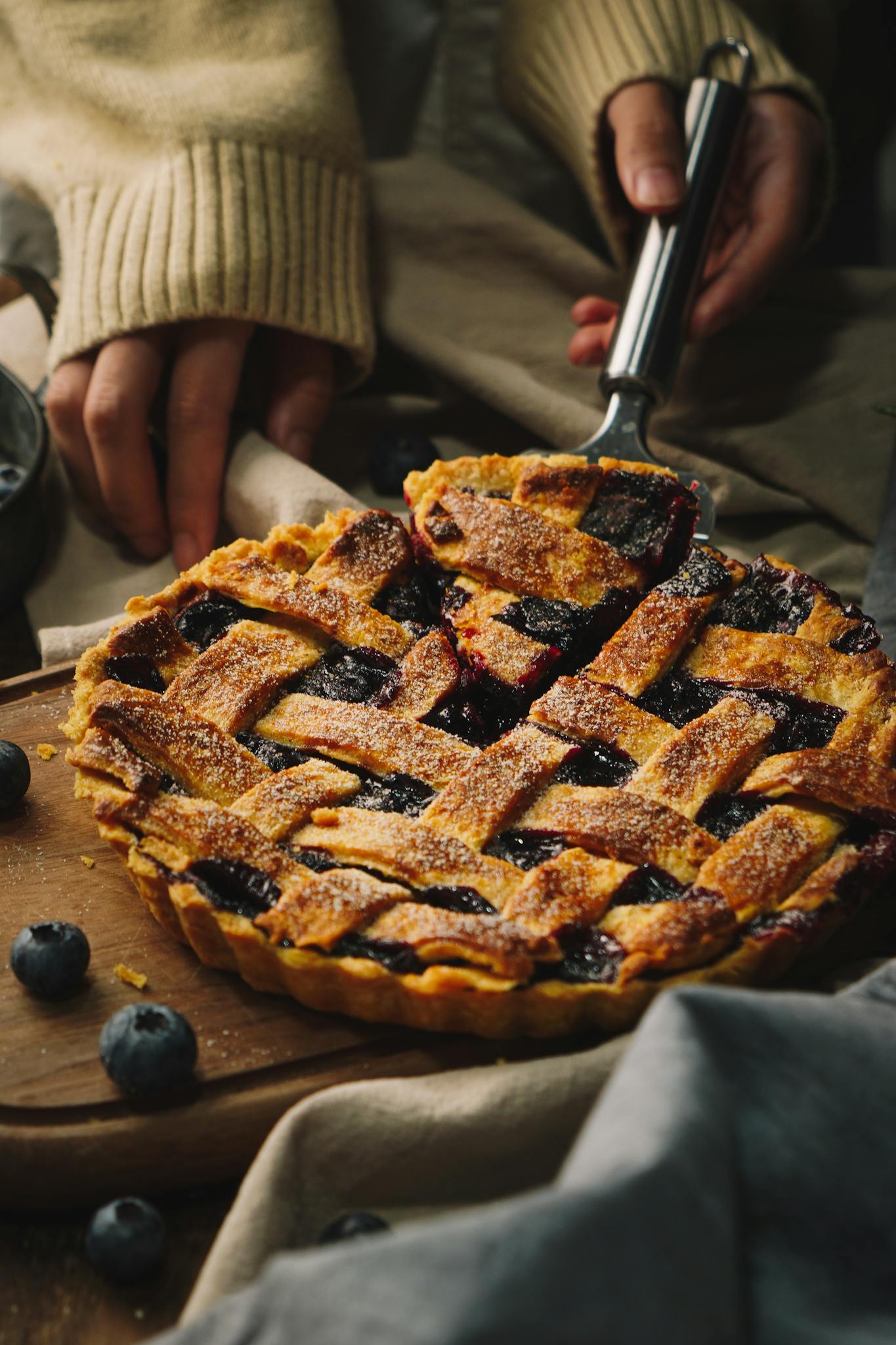 Delicious homemade blueberry pie on a wooden board, showcasing an elegant lattice crust, perfect for dessert lovers.